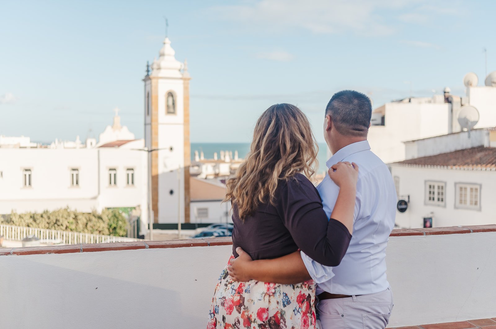 Old Town Albufeira family and couples photographer - a picture of a couple looking over the town view of Albufeira and ocean