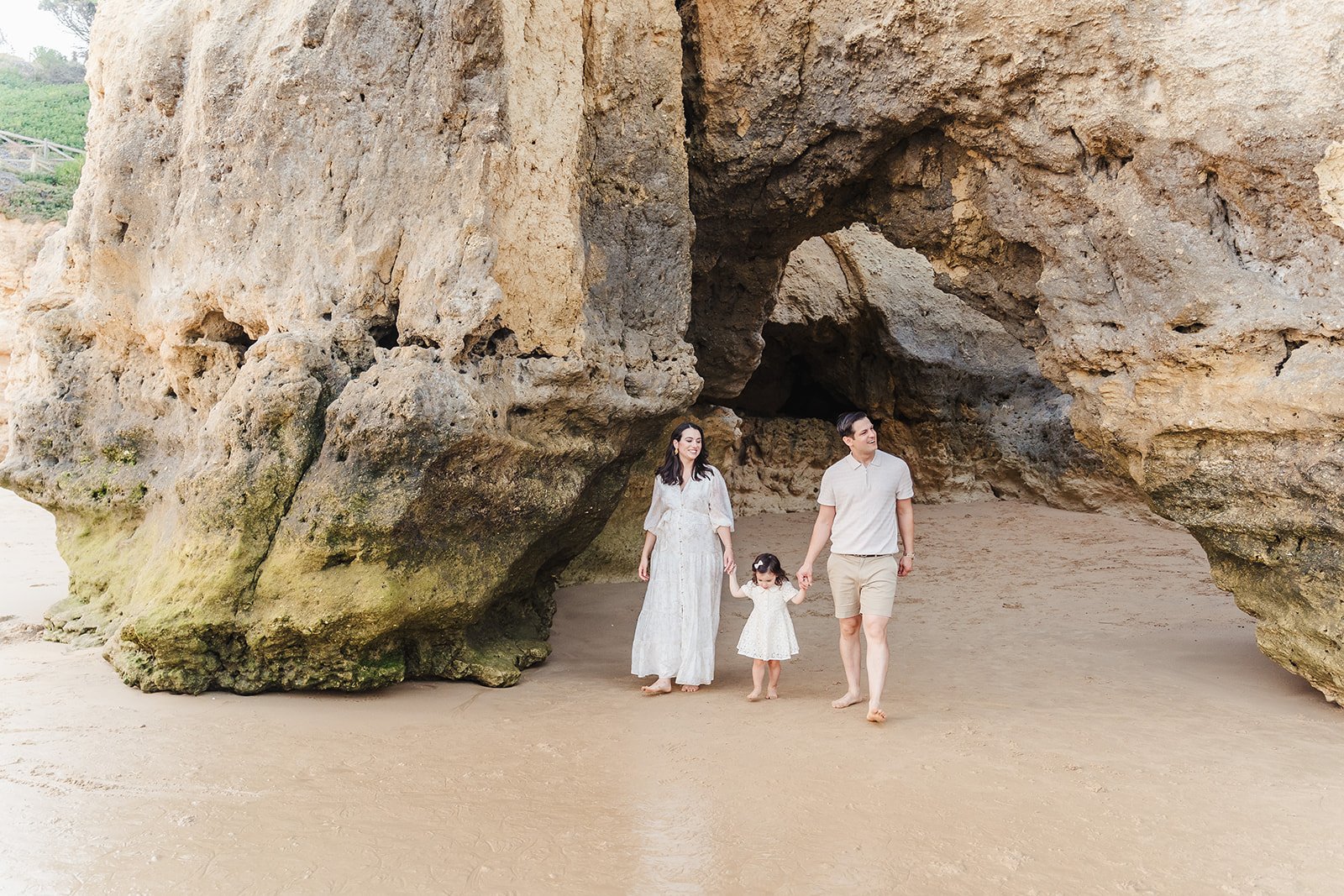Children running on red-cliff beach at Praia da Falésia, Albufeira