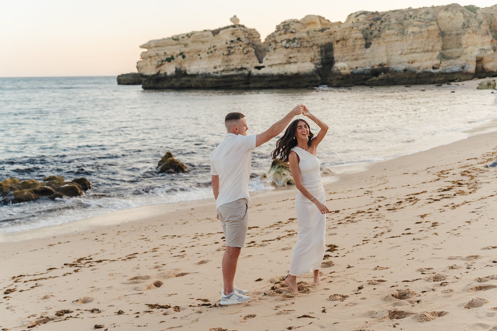 Sunset engagement photoshoot at Sao Rafael beach near Kimpton Atlantico Algarve in Albufeira, Portugal